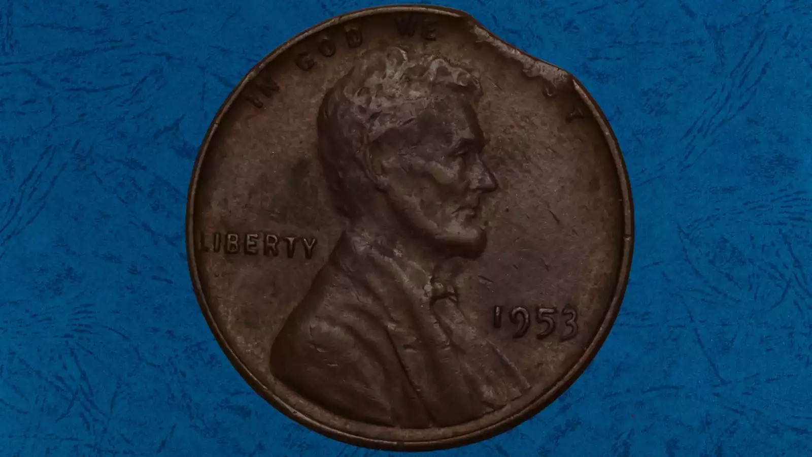 1953 wheat penny curved clipped planchet error showing crescent-shaped missing section at the coin edge